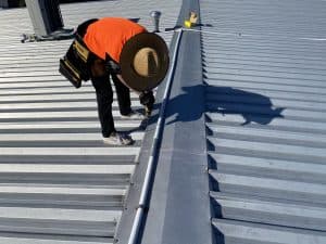 Roof inspection and preparation—ensuring optimal adhesion for long-lasting results.